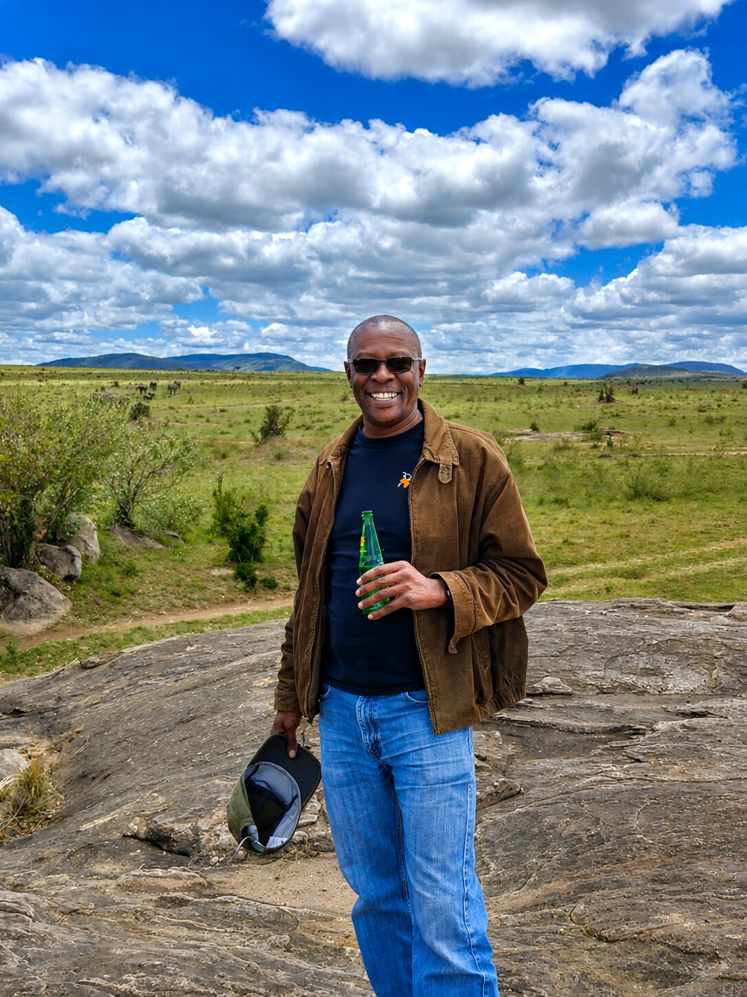 Kinuthia Njenga smiling on the savanna in Kenya